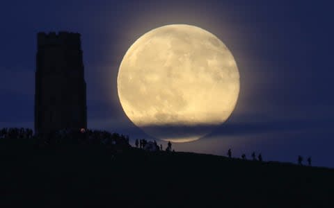 The so-called 'Strawberry Moon' rises behind Glastonbury Tor on in June 2016.  - Credit: Matt Cardy/Getty Images