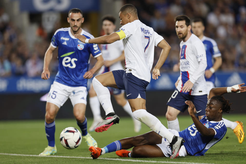 PSG's Kylian Mbappe, centre, in action during the French League One soccer match between Strasbourg and Paris Saint Germain at Stade de la Meinau stadium in Strasbourg, eastern France, Saturday, May 27, 2023. (AP Photo/Jean-Francois Badias)
