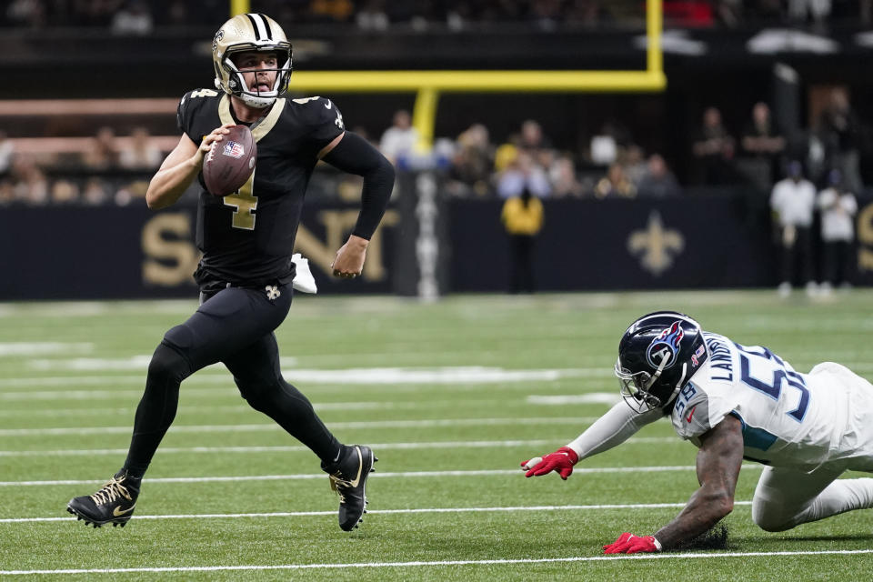 New Orleans Saints quarterback Derek Carr (4) runs away from Tennessee Titans linebacker Harold Landry III in the first half of an NFL football game in New Orleans, Sunday, Sept. 10, 2023. (AP Photo/Gerald Herbert)