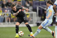 Nashville SC forward Tyler Boyd (11) kicks the ball past CF Montréal midfielder Samuel Piette (6) during the second half of an MLS soccer match Saturday, May 4, 2024, in Nashville, Tenn. Nashville SC won 4-1. (AP Photo/George Walker IV)