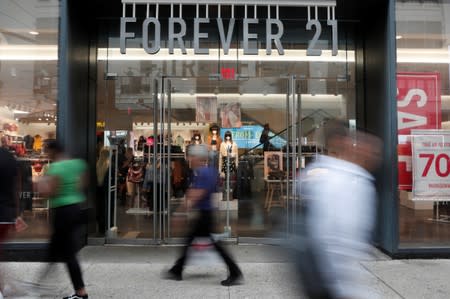 People walk by the clothing retailer Forever 21 in New York City