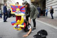 Tibetan monk Golog Jigme holds a Tibetan flag during protests outside the Beijing 2022 Winter Olympic Candidate City presentation at the Palace hotel in Lausanne, Switzerland in this June 10, 2015 file photo. REUTERS/Ruben Sprich/Files