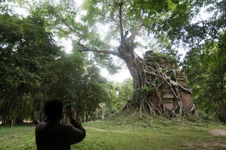 A tourist visits Sambor Prei Kuk, or "the temple in the richness of the forest" an archaeological site of ancient Ishanapura, is seen after being listed as a UNESCO world heritage site, in Kampong Thom province, Cambodia July 15, 2017. Picture taken July 15, 2017. REUTERS/Samrang Pring