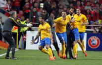 Juventus' Carlos Tevez, second left, celebrates with teammates after scoring his side's first goal against Benfica during the Europa League semifinal first leg soccer match between Benfica and Juventus at Benfica's Luz stadium in Lisbon, Thursday, April 24, 2014. (AP Photo/Francisco Seco)