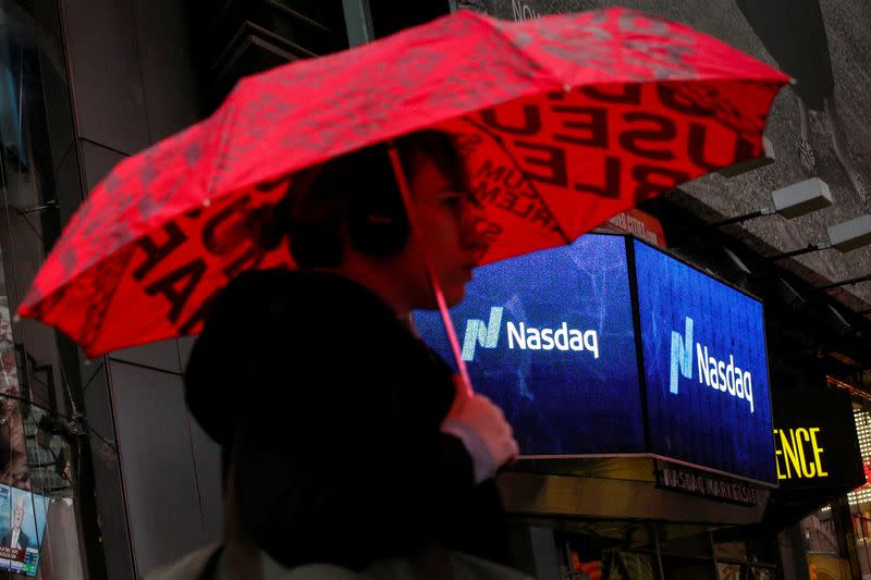 A woman passes by the Nasdaq Market Site in Times Square in New York