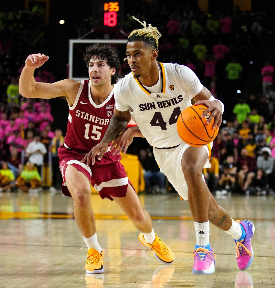 ASU guard Adam Miller (44) drives against Stanford guard Benny Gealer (15) during a game at Desert Financial Arena.