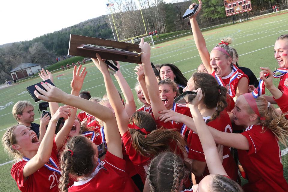 The Redhawks celebrate with the trophy after their 1-0 win over MMU in the D1 Championship game on Sunday afternoon at Norwich University.