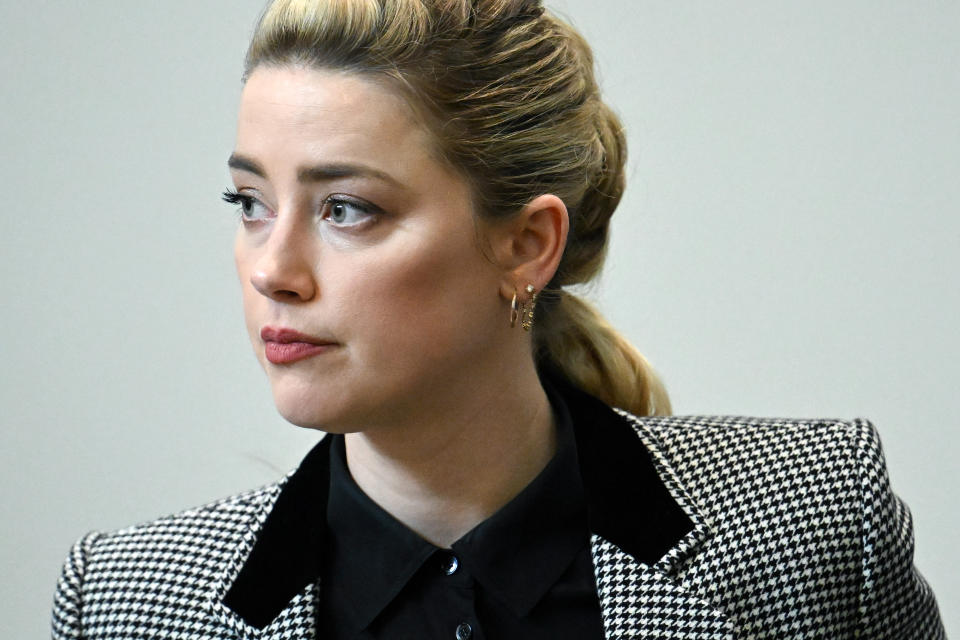 Actor Amber Heard appears in the courtroom at the Fairfax County Circuit Courthouse in Fairfax, Va., Tuesday, May 24, 2022. Depp sued his ex-wife Amber Heard for libel in Fairfax County Circuit Court after she wrote an op-ed piece in The Washington Post in 2018 referring to herself as a "public figure representing domestic abuse." (Jim Watson/Pool photo via AP)