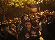 A gay rights activist carries a child on his shoulders as he attends a protest against a verdict by the Supreme Court in New Delhi December 11, 2013. India's Supreme Court on Wednesday reinstated a ban on gay sex in the world's largest democracy, following a four-year period of decriminalisation that had helped bring homosexuality into the open in the socially conservative country. In 2009 the Delhi High Court ruled unconstitutional a section of the penal code dating back to 1860 that prohibits "carnal intercourse against the order of nature with any man, woman or animal" and lifted the ban for consenting adults. The Supreme Court threw out that decision, saying only parliament could change Section 377 of the penal code, widely interpreted to refer to homosexual sex. Violation of the law can be punished with up to 10 years in jail. (REUTERS/Anindito Mukherjee)