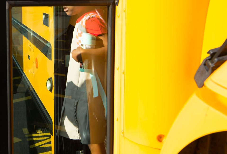 A student gets off the school bus on the first day of school on Aug. 8, 2023, at Goodlettsville Elementary School in Goodlettsville, Tenn.
