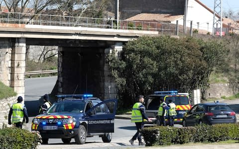 French gendarmes block the access to Trebes, where a man took hostages at a supermarket - Credit: ERIC CABANIS /AFP