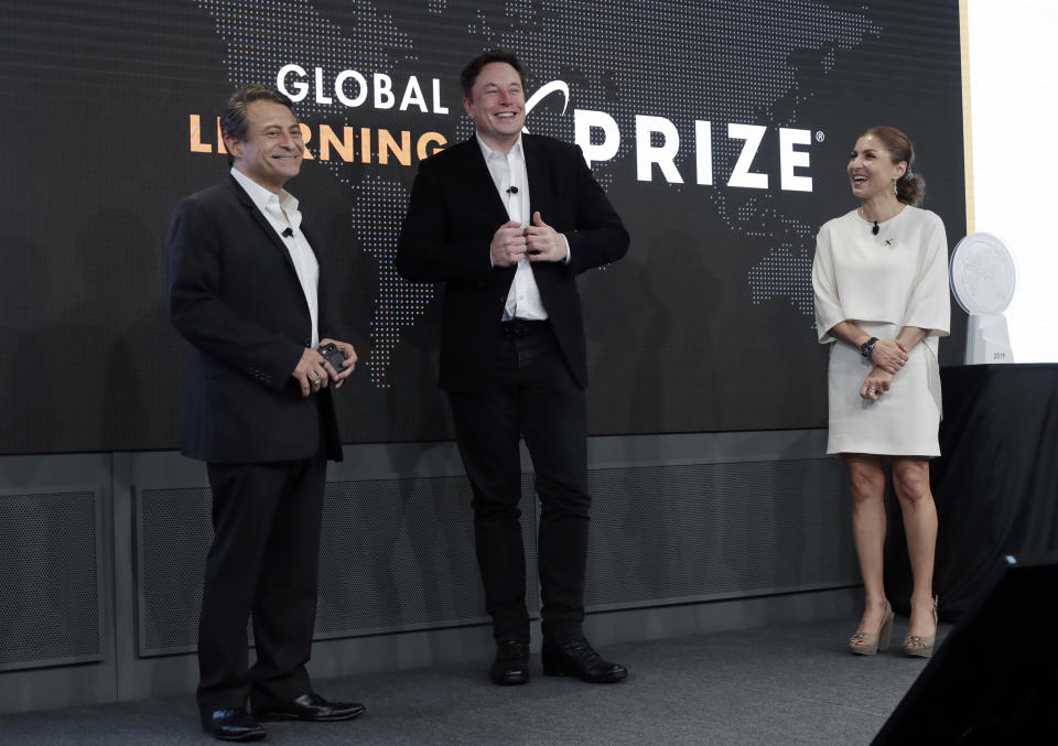 Tesla CEO Elon Musk, center, joins XPRIZE founder Peter Diamandis, left, and CEO Anousheh Ansari during the presentation of the XPRIZE for Children's Literacy Wednesday, May 15, 2019, in Los Angeles. The Berkeley-based Kitkit School and London's onebillion educational nonprofit were declared co-winners of the XPRIZE For Global Learning at a presentation Wednesday night. (AP Photo/Marcio Jose Sanchez)