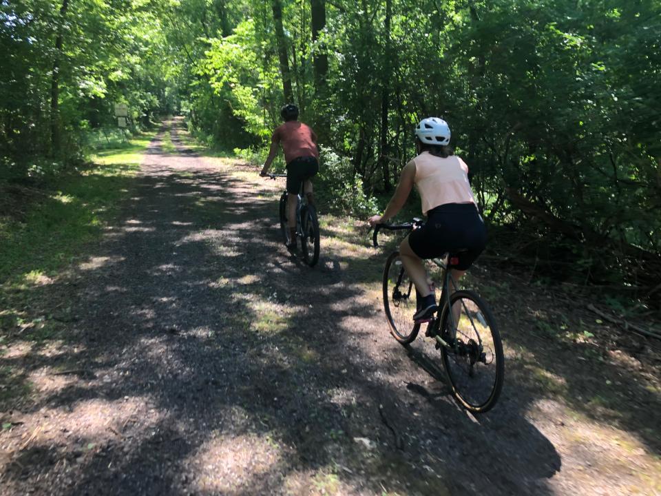 Cyclists ride a dirt drive that links several of the preliminary trails that have been cut on the Portage Manor property in South Bend during an open house for trails on June 15, 2024.