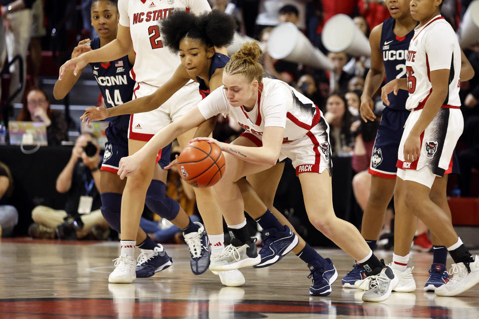 North Carolina State's Laci Steele, center right, battles for the ball with UConn's Qadence Samuels, center left, during the first half of an NCAA college basketball game, Sunday, Nov. 12, 2023, in Raleigh, N.C. (AP Photo/Karl B. DeBlaker)