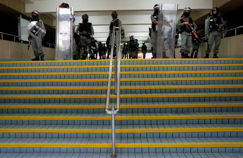 Riot police members block a corridor of a shopping mall in Tai Po in Hong Kong