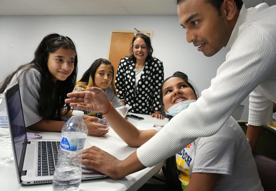 Musician and Syracuse University student Rufus Sivaroshan, right, teaches children doing audio engineering training at Step Ahead Tech. Those watching include, from left, Aapshana Bhattarai, 11; Shamekcha Bhattarai, 16; camp cofounder Sarala Pandey; and Omni Bajgai, 12.