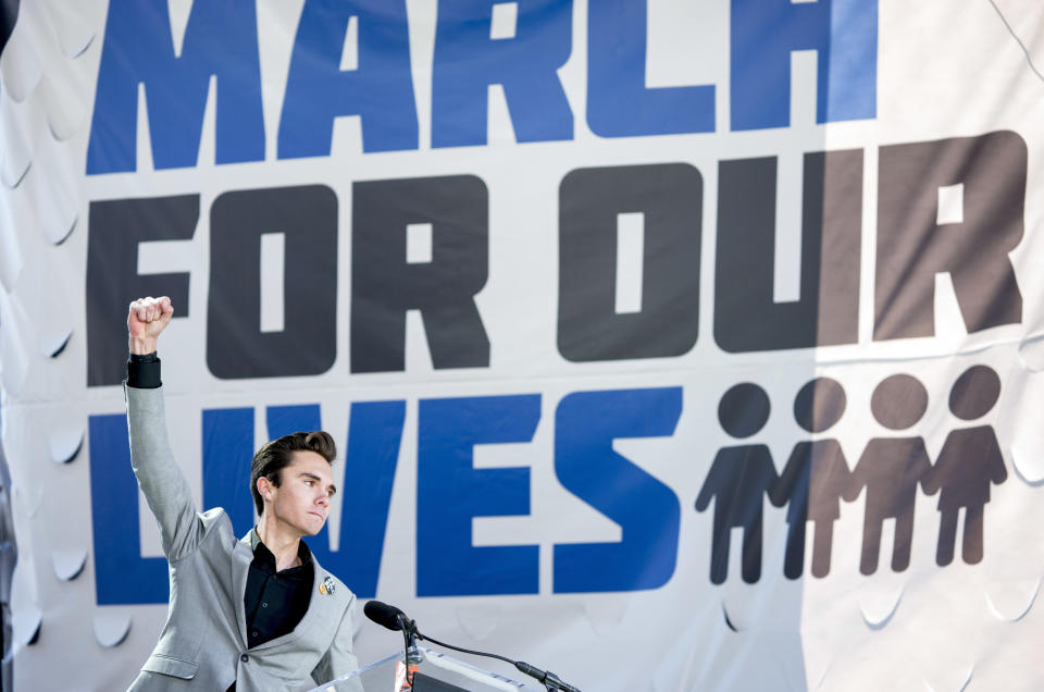 FILE - In this March 24, 2018, file photo, David Hogg, a survivor of the mass shooting at Marjory Stoneman Douglas High School in Parkland, Fla., raises his fist after speaking during the March for Our Lives rally in support of gun control in Washington. March For Our Lives and the Giffords group, two prominent gun safety organizations, say they'll host a forum for Democratic presidential candidates in Las Vegas on Oct. 2, 2019, the day after the second anniversary of the deadliest mass shooting in modern U.S. history. The organizations told The Associated Press that the forum focused on gun violence will be the first of its kind for presidential hopefuls and will be open to all candidates who meet the Democratic National Committee’s polling and fundraising thresholds for the September debate. (AP Photo/Andrew Harnik, File)