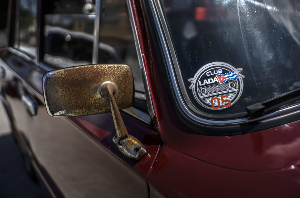 A Soviet-era Lada car with a "Club Lada" sticker is parked during a meeting of the Lada Cuba Club in Havana, Cuba, Sunday, March 21, 2021. The club has about 140 members who meet for social activities like donating blood, assisting each other when breakdowns happen or just trading quick-fix tricks and parts. (AP Photo/Ramon Espinosa)