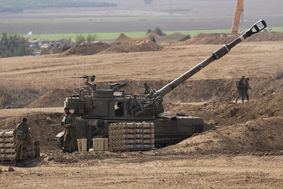 FILE - An Israeli mobile artillery unit is seen in a position near the Israel-Gaza border, Israel Oct. 28, 2023. Over the past five days, Israeli ground troops have pushed deeper and deeper into Gaza in their war against Hamas, launched in response to a bloody Oct. 7 cross-border raid by the Islamic militant group. Yet even as the operation expands each day, the army refuses to call it an invasion. Its vague choice of words appears to be a deliberate strategy aimed at keeping its enemy off balance and preserving its options as a lengthy war unfolds. (AP Photo/Ohad Zwigenberg, File)