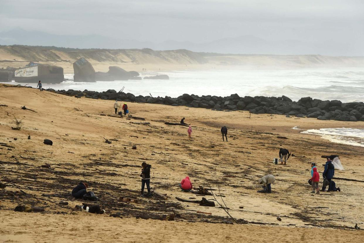 People walk on the beach in Capbreton, southwestern France, where cocaine packages have been found last days: AFP via Getty Images