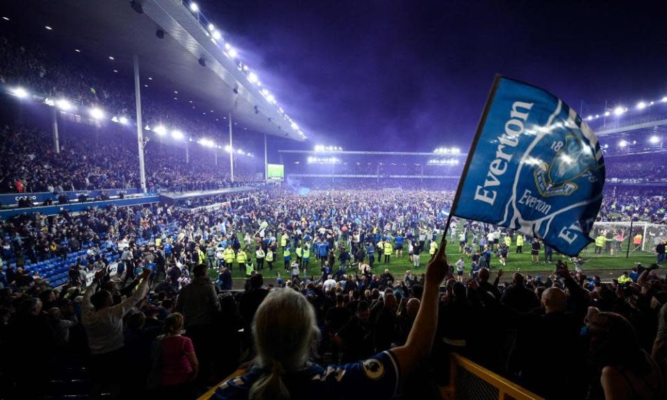 Everton fans pour onto the pitch at full-time.