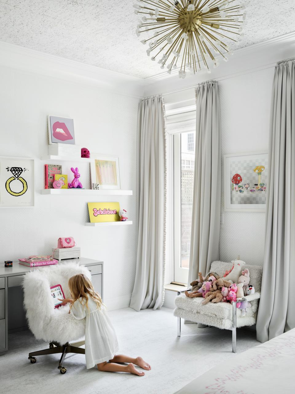 Artworks by Donald Baechler (above Desk) and Takashi Murakami (above Shearling-Covered Armchair) mix with an RH baby & child desk and chair and a chandelier from CB2 in the daughter’s room. © 2020 Donald Baechler / Artists Rights Society (ARS), New York