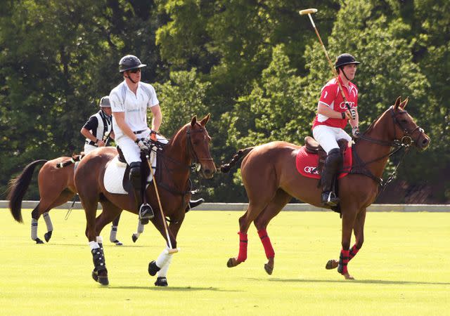 <p>David M. Benett/Getty</p> Prince Harry and Jack Mann play in the Audi Polo Challenge in London, England in 2015.