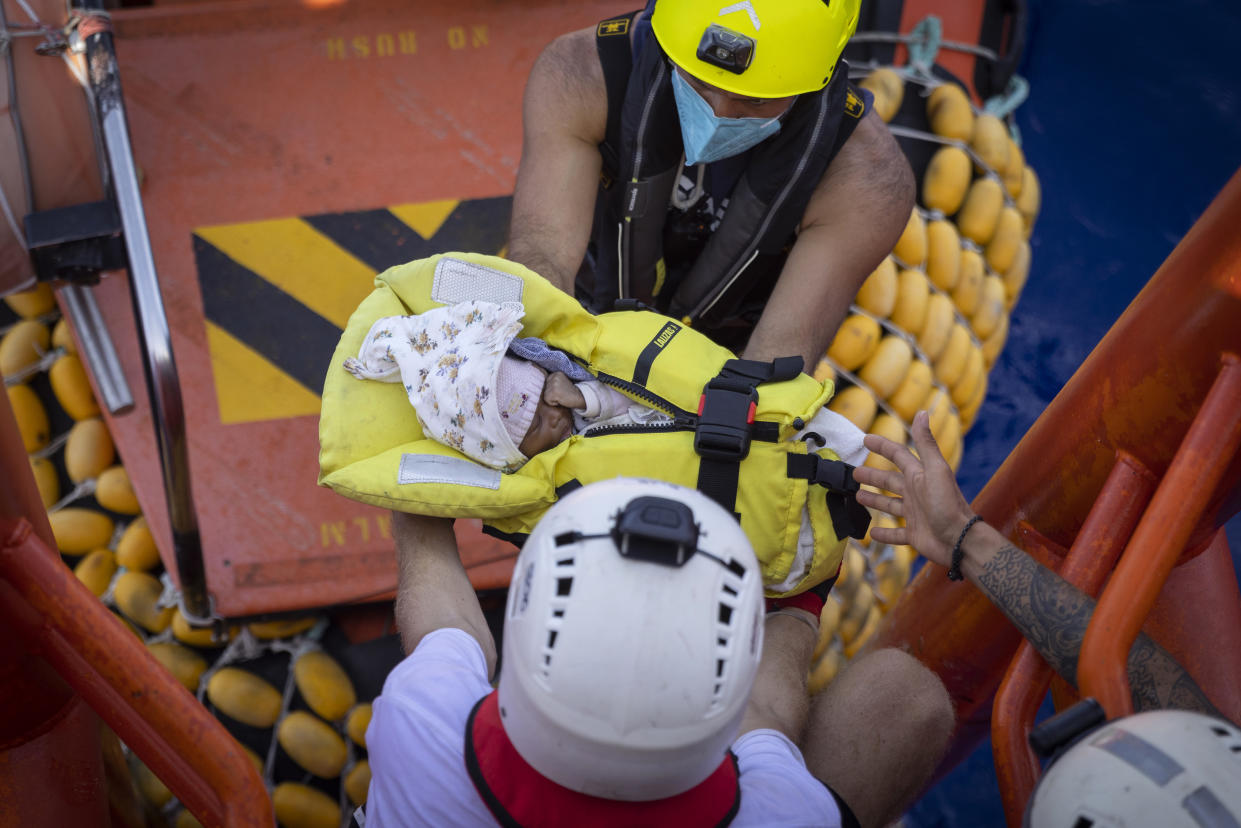 A three-week old baby is evacuated from the Ocean Viking, a migrant search and rescue ship run by NGOs SOS Mediterranee and the International Federation of Red Cross (IFCR), Monday, Aug. 29, 2022 in the Mediterranean Sea. Two 9-month-pregnant women whose pregnancy were at risk, travelling with their sisters and two children, including the 3-week-old girl were transferred to an Italian coastguard vessel fort rated. 466 migrants are on board the Ocean Viking. (AP Photo/Jeremias Gonzalez).