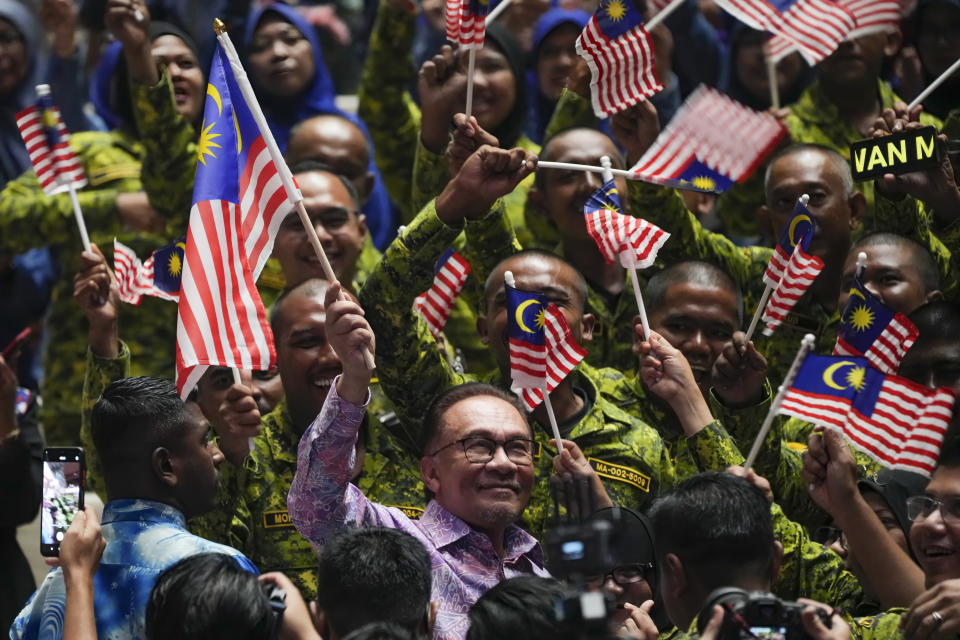 Malaysian Prime Minister Anwar Ibrahim waves national flag after deliver his speech for National Day at a convention centre in Putrajaya, Malaysia Wednesday, Aug. 30, 2023. Anwar made his first National Day address since taking over as Prime Minister in November last year. (AP Photo/Vincent Thian)