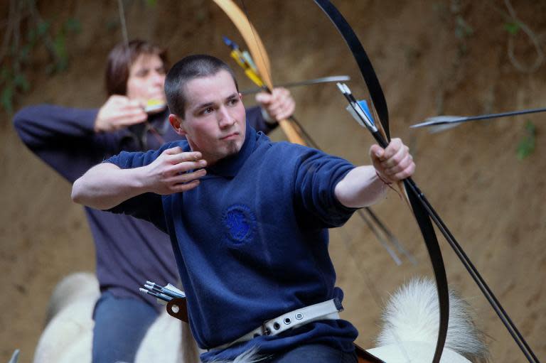 A students of Lajos "The Master" Kassai learn horseback archery at the indoor hall of the 'Valley' in Kaposmero village, south Hungary on March 7, 2015