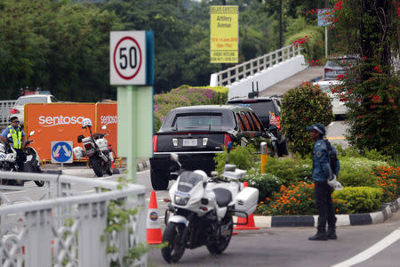 A motorcade transporting U.S. President Donald Trump drives in Sentosa towards the Capella Hotel on Singapore's resort island of Sentosa for his meeting with North Korean leader Kim Jong Un June 12, 2018. REUTERS/Athit Perawongmetha