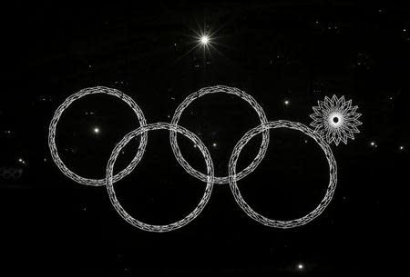 Four of five Olympic rings are seen lit up during the opening ceremony of the 2014 Sochi Winter Olympics, February 7, 2014. REUTERS/Phil Noble