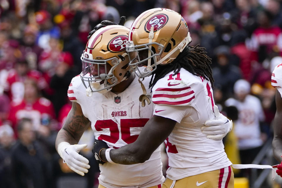 San Francisco 49ers running back Elijah Mitchell (25) celebrating his touchdown with teammate wide receiver Brandon Aiyuk (11) during the second half of an NFL football game against the Washington Commanders, Sunday, Dec. 31, 2023, in Landover, Md. (AP Photo/Alex Brandon)