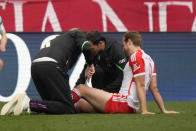 Bayern's Harry Kane is assisted during the German Bundesliga soccer match between Bayern Munich and Eintracht Frankfurt, at the Allianz Arena in Munich, Germany, Saturday, April 27, 2024. (AP Photo/Matthias Schrader)