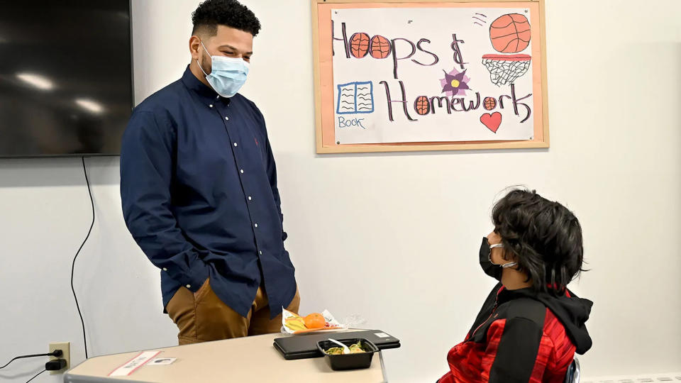 Hoops and Homework Program Director Kevin Lopez chats with Maryin Garcia last spring at the academic enrichment center and recreation program's headquarters in Framingham.