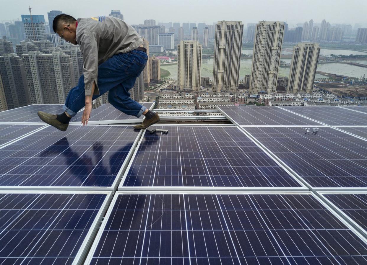 <span class="caption">Reducing fossil use and increasing renewable energy worldwide are crucial to both sustainable development and fighting climate change.</span> <span class="attribution"><a class="link " href="https://www.gettyimages.com/detail/news-photo/chinese-worker-from-wuhan-guangsheng-photovoltaic-company-news-photo/684080492" rel="nofollow noopener" target="_blank" data-ylk="slk:Kevin Frayer/Getty Images;elm:context_link;itc:0;sec:content-canvas">Kevin Frayer/Getty Images</a></span>