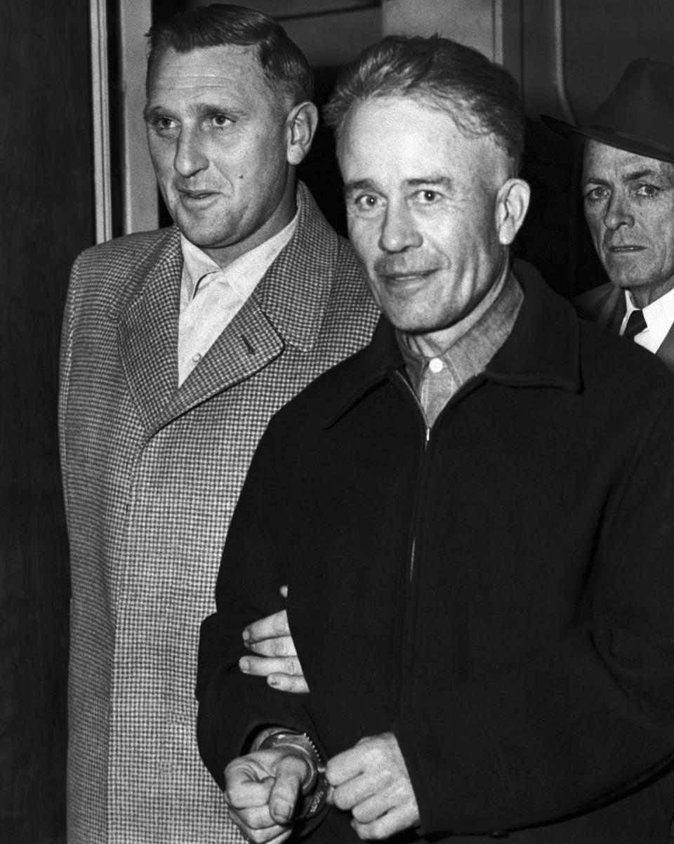 Serial killer Ed Gein is escorted from the Wisconsin State Crime Laboratory to the county jail after confessing to two murders.