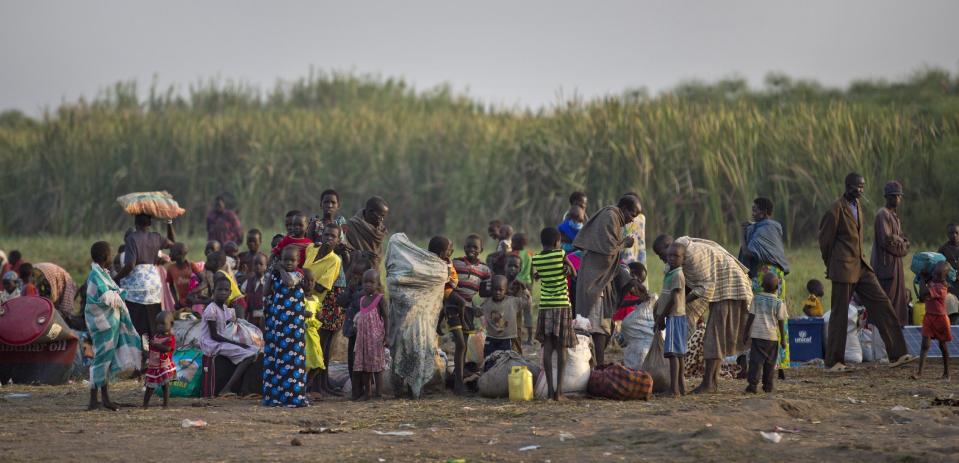 Displaced people rest after getting off a river barge from Bor, some of the thousands who fled the recent fighting between government and rebel forces in Bor by boat across the White Nile, in the town of Awerial, South Sudan Thursday, Jan. 2, 2014. The international Red Cross said Wednesday that the road from Bor to the nearby Awerial area "is lined with thousands of people" waiting for boats so they could cross the Nile River and that the gathering of displaced is "is the largest single identified concentration of displaced people in the country so far". (AP Photo/Ben Curtis)