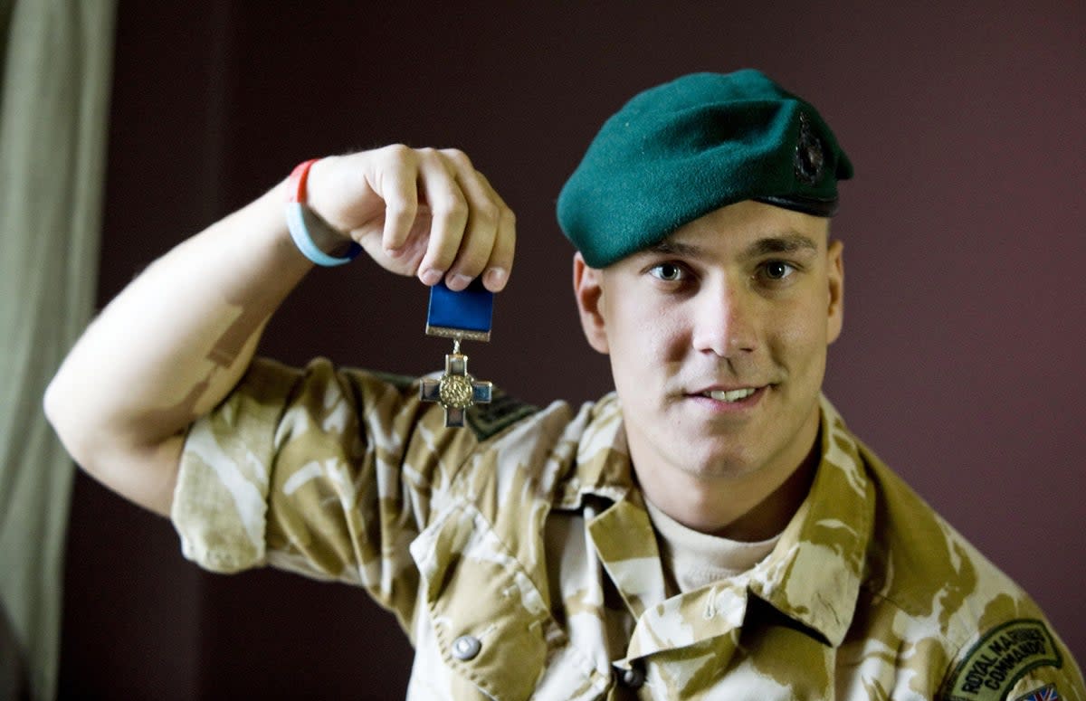 Matt Croucher in 2010 with the George Cross he received for his work in Afghanistan  (PA)