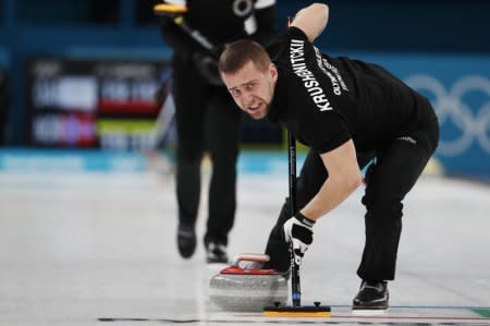 Curling – Pyeongchang 2018 Winter Olympics – Mixed Doubles Bronze Medal Match - Olympic Athletes from Russia v Norway - Gangneung Curling Center - Gangneung, South Korea – February 13, 2018 - Alexander Krushelnitsky, an Olympic athlete from Russia, sweeps. Picture taken February 13, 2018. REUTERS/Cathal McNaughton