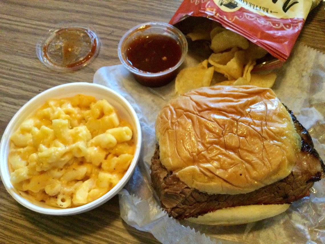 A beef brisket sandwich with sweet and spicy barbecue sauce, smoked mac-n-cheese and a bag of kettle chips from the Smoke South Craft BBQ and Catering mobile food truck.