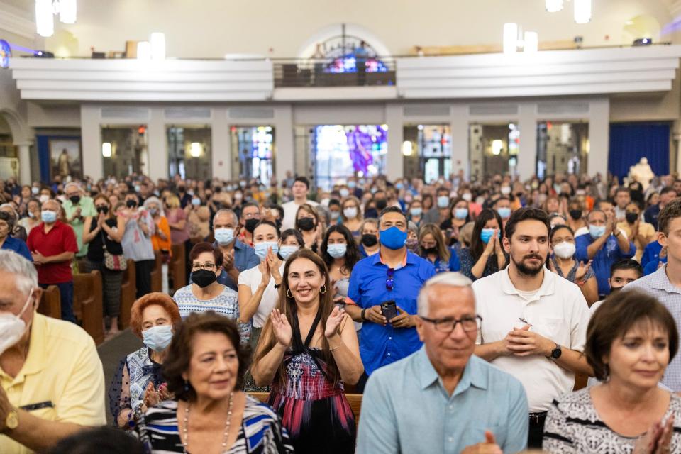 Parishioners cheer in celebration at the start of the last Mass of Monsignor Arturo J. Bañuelas at Saint Mark’s Catholic Church, in El Paso, Texas, Sunday, July 10, 2022.