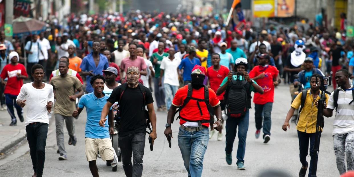 Armed off-duty police officers protest over police pay and working conditions, in Port-au-Prince, Haiti, Sunday, Feb. 23, 2020.