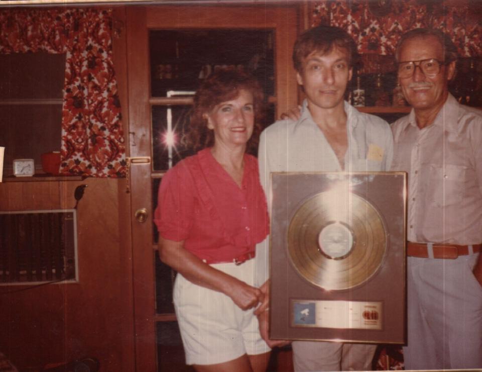 Rick Anderson of the Tubes with his parents, holding the gold record he received for "The Completion Backward Principle."