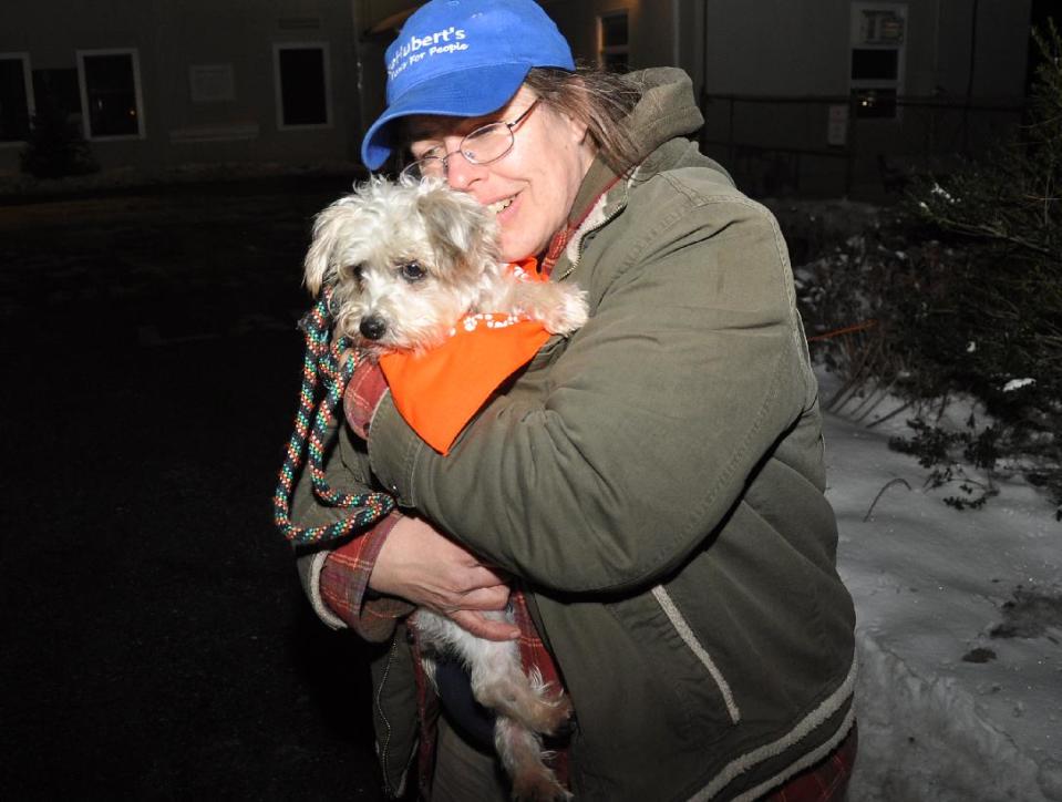 FILE - In this Dec. 18 photo provided by the American Society for the Prevention of Cruelty to Animals, ASPCA, shows Melissa Morgan, a kennel attendant and adoption counselor holding Josie, a terrier/poodle mix, about 4-5 years old arriving at St. Hubert’s Animal Welfare Center in Madison, N.J. Josie was one of the last of 45 Tennessee dogs to be adopted , after the dogs were rounded up at overcrowded shelters in Tennessee and brought to St. Hubert’s, which had enough open kennels for all the dogs. (AP Photo/ ASPCA, Anita Edson)