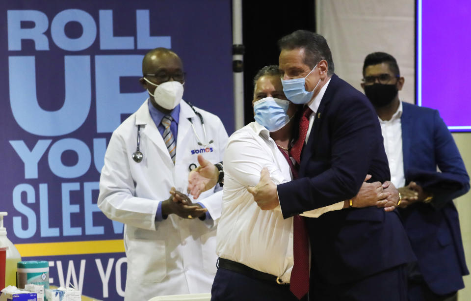 Gov. Andrew Cuomo embraces Radhames Rodriguez, President of United Bodegas of America, after Rodriguez received a Pfizer COVID-19 vaccination shot at an event to announce five new walk-in pop-up COVID-19 vaccination sites for New York Bodega, grocery store and supermarket workers in the Harlem section of New York on Friday, April 23, 2021. (Mike Segar/Pool Photo via AP)