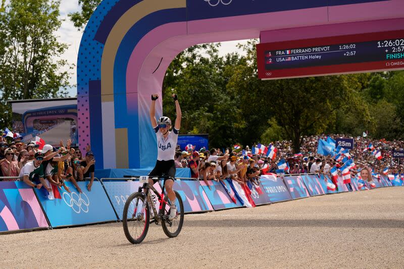 Haley Batten, of United States, crosses the finish line to win the silver medal in the women's mountain bike cycling event, at the 2024 Summer Olympics, Sunday, July 28, 2024, in Elancourt, France. | George Walker IV