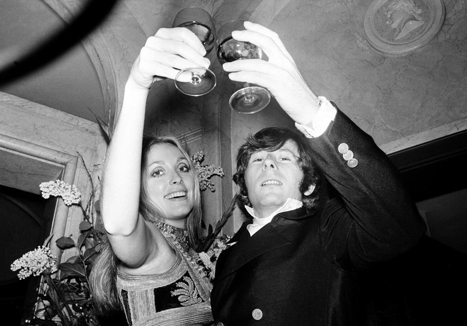 <p>Film director Roman Polanski and his wife, Sharon Tate, lift their glasses in a toast at the premiere of his film “Rosemary’s Baby” in London on Jan. 23, 1969. (Photo: AP) </p>