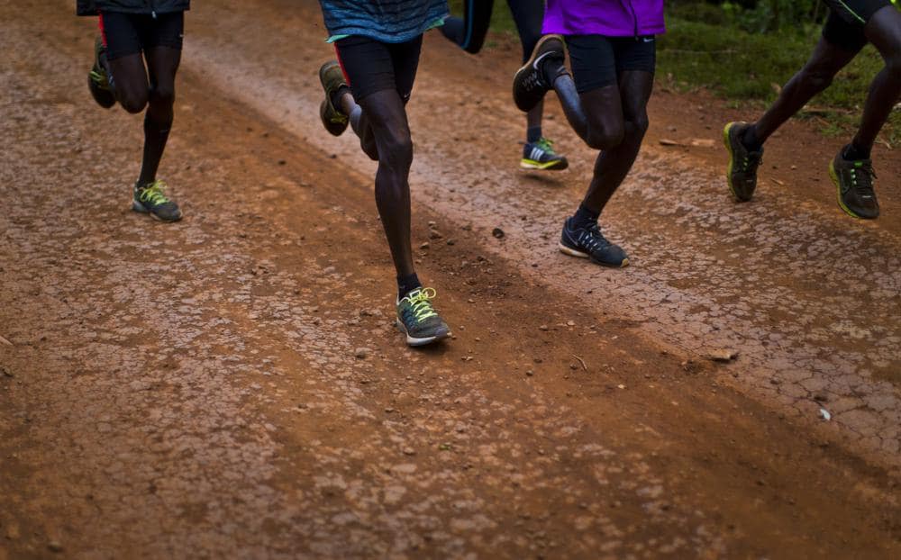 Kenyan athletes train together just after dawn on a dusty track in Kaptagat Forest in western Kenya, on Jan. 30, 2016. (AP Photo/Ben Curtis, File)