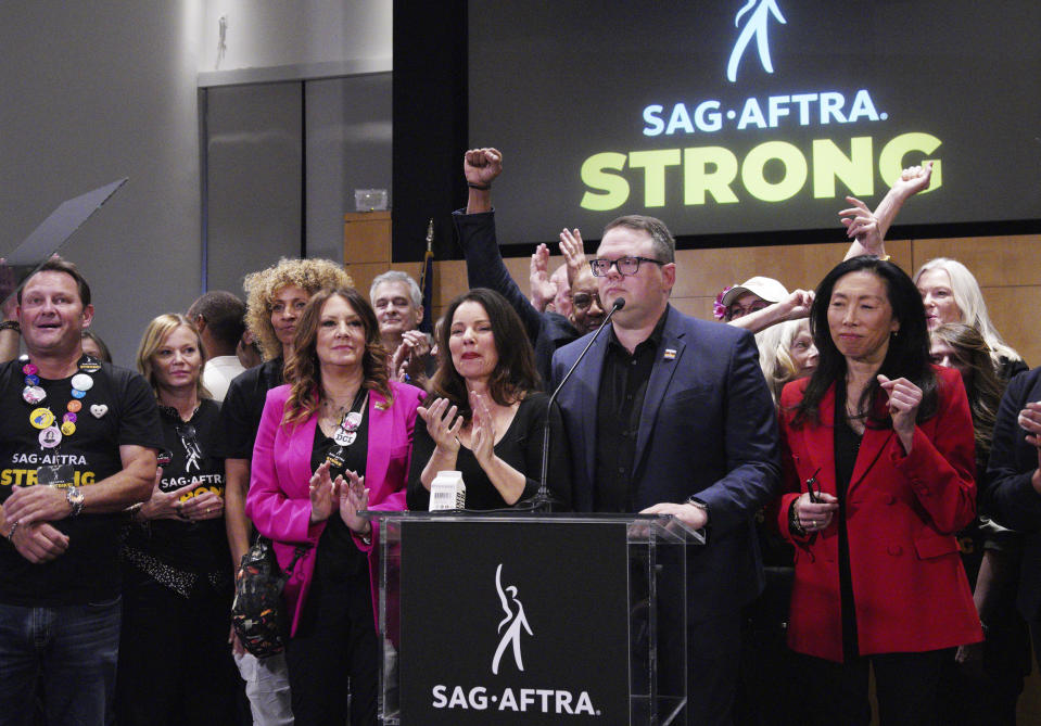 SAG-AFTRA President Fran Drescher, center with National Executive Director and Chief Negotiator Duncan Crabtree-Ireland at podium are joined by the TV/Theatrical Negotiating Committee members speak during a news conference at the SAG-AFTRA offices in Los Angeles on Friday, Nov. 10, 2023. The actors' union officially ended its 118-day strike in November. (AP Photo/Richard Vogel)